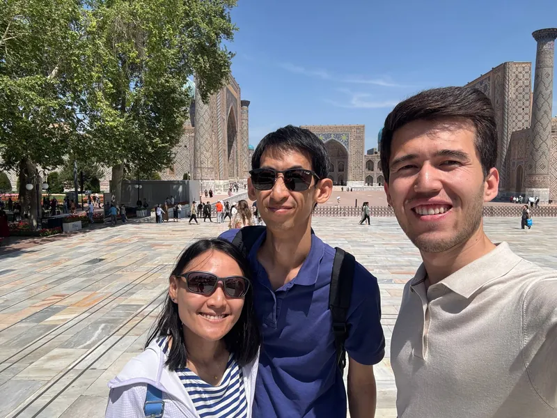 Our guide with two guests at Registan Square, Samarkand